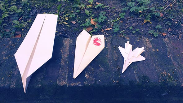 A normal paper plane next to F15 Eagle Jet Fighter paper plane.