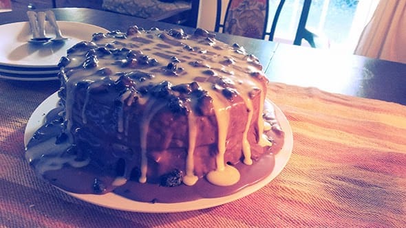 A chocolate cake covered Oreo crumbles and vanilla buttercream.