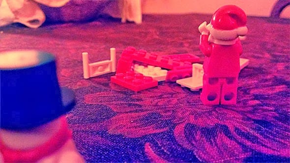 Lego santa is distraught to find his sledge destroyed by LegoFrosty the Snowman.