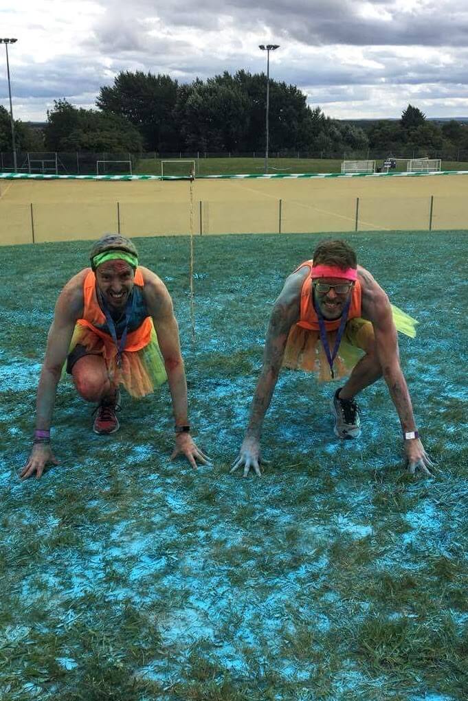 Carlos and Ben in the Ace Ventura pose, looking ready to run despite having already run.