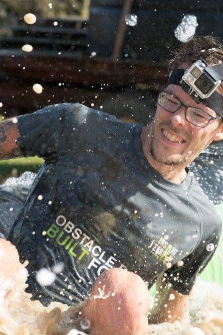 Carlos Eriksson hitting the pool of water at the end of the foam slide.