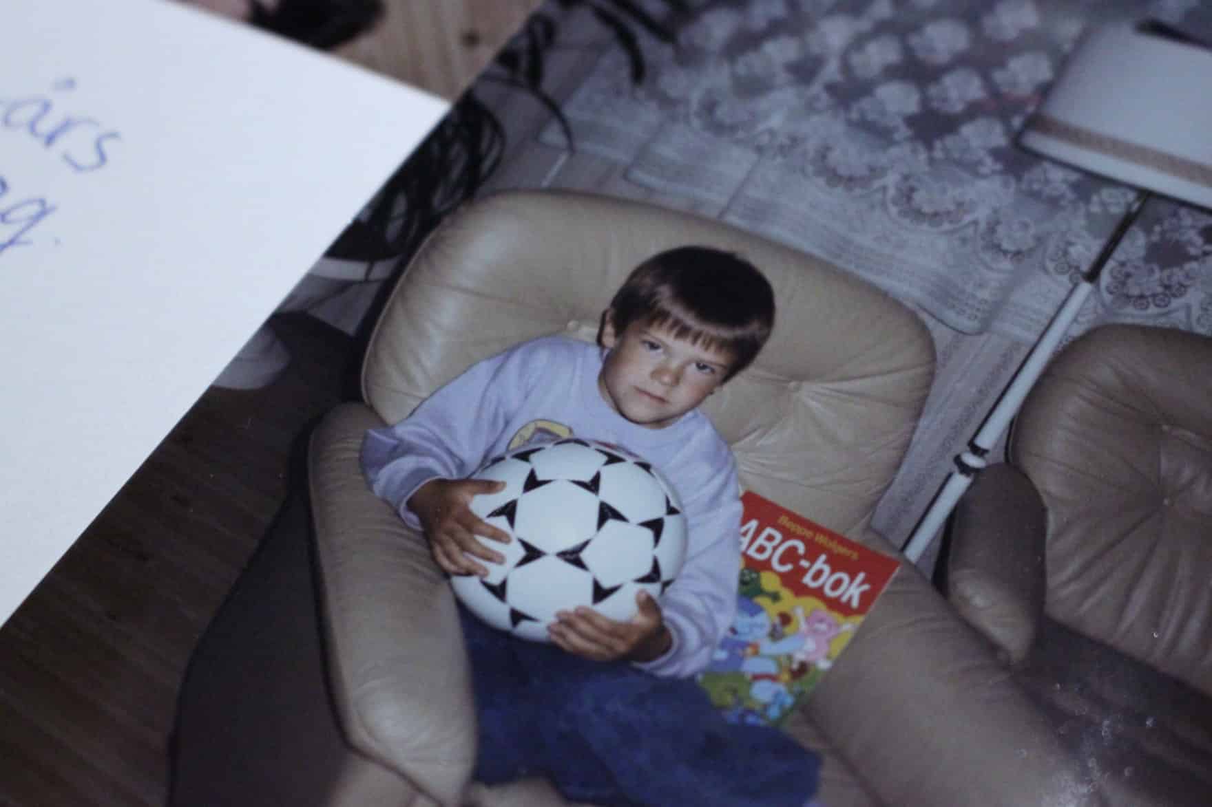 Carlos, 6-years-old, sitting in an armchair, looking stern on his birthday.